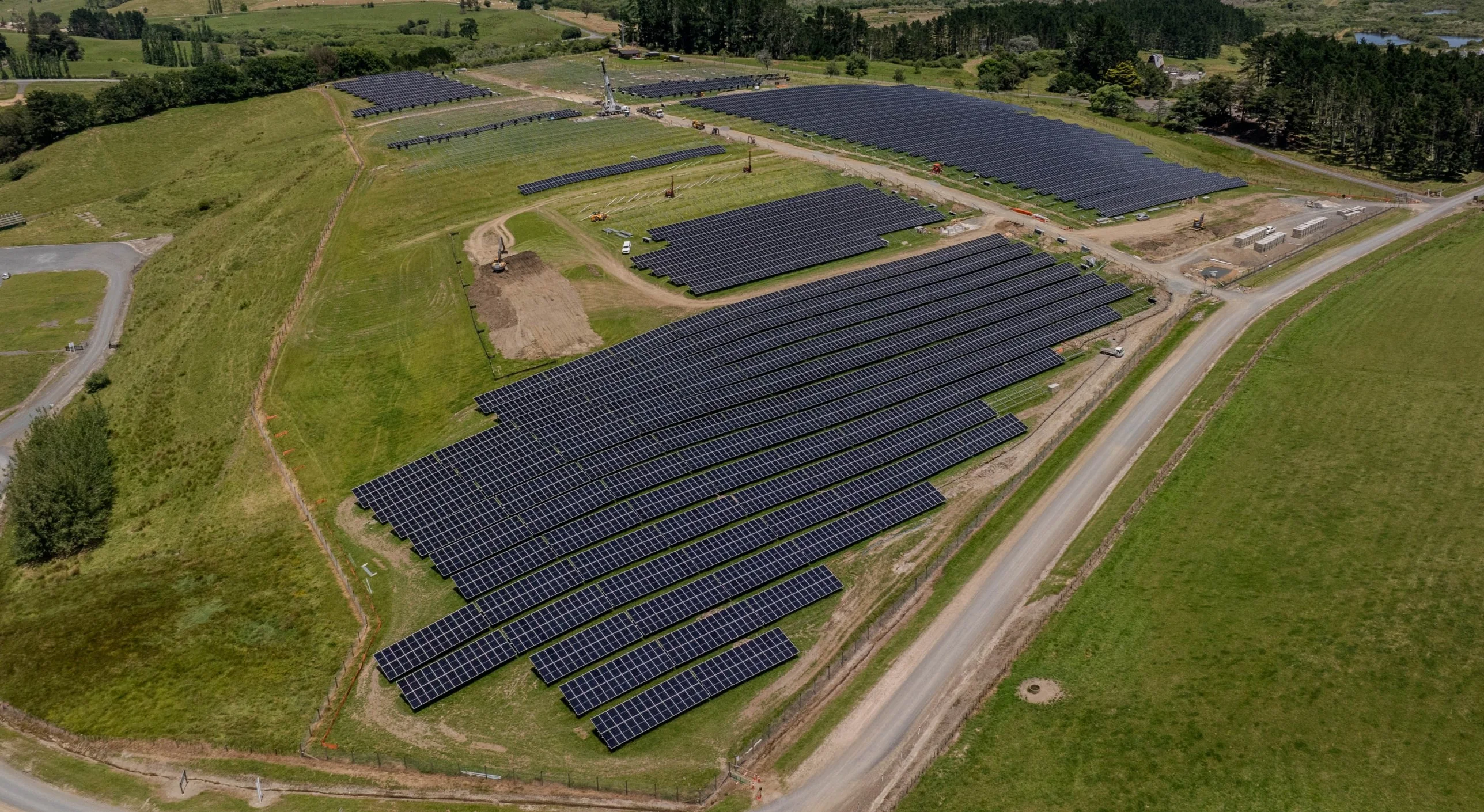 Aerial view of a solar farm in green New Zealand countryside
